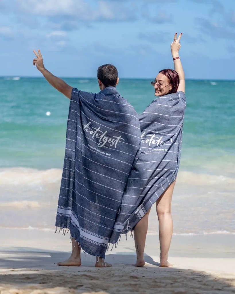 Equipo Hotelgest en la playa con toallas hotelgest